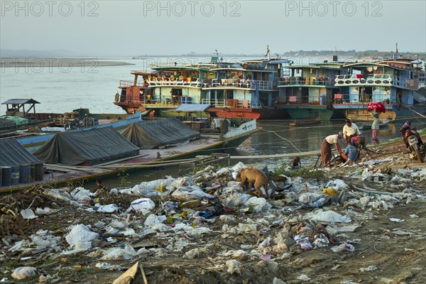 Garbage and ships at the river bank