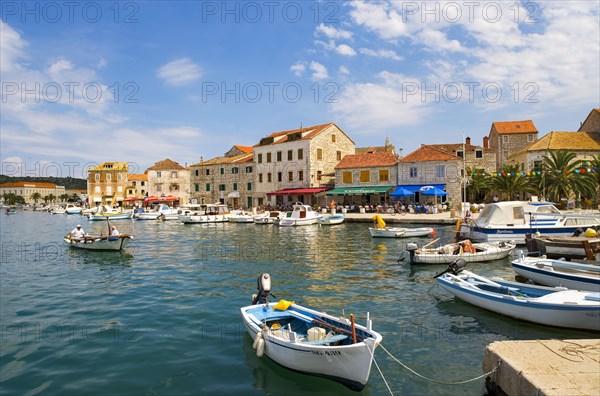 Promenade with fishing boats in the port