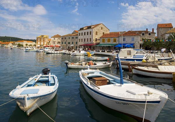 Promenade with fishing boats in the port