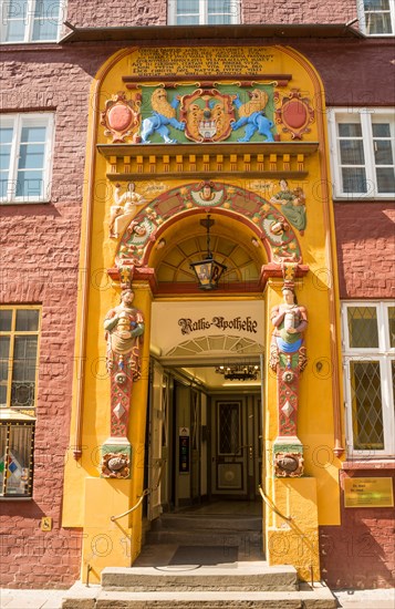 Decorative entrance with coat of arms and figures