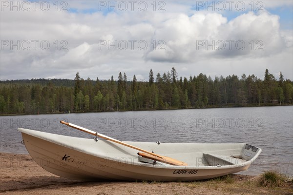 Landscape photo boat on the lake shore. Near Posio