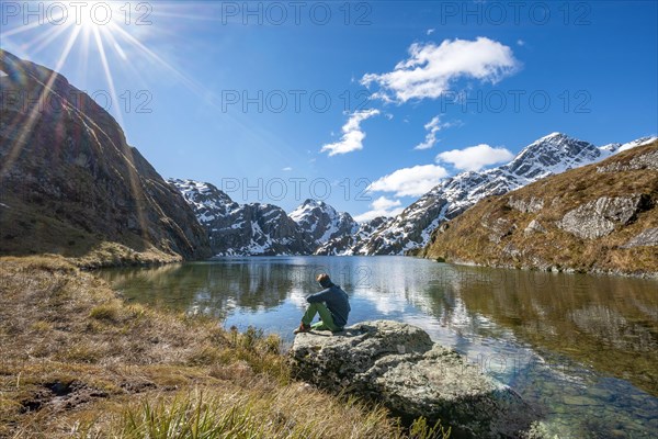 Young man sitting on a rock