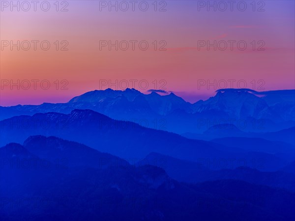 Blue mountain silhouettes at sunrise