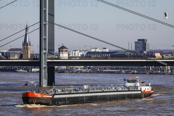 Freighters navigating at high water on the Rhine under the Rheinkniebruecke