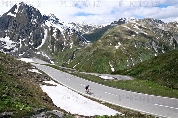 Racing cyclist on the Nufenen Pass in the Swiss Alps