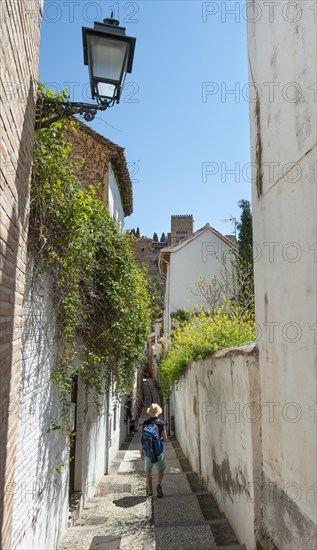 Young man standing in an alley