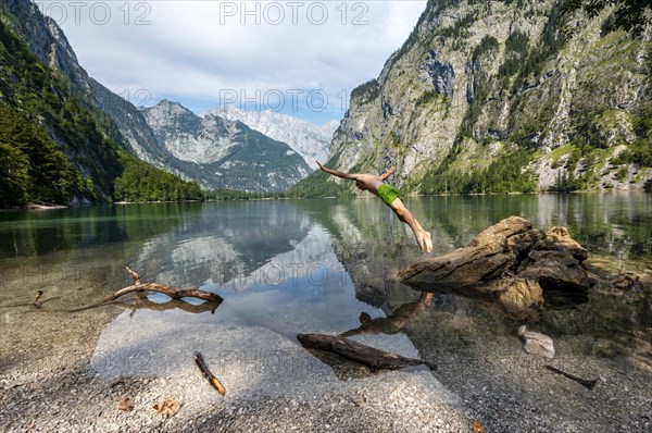 Young man jumps into lake