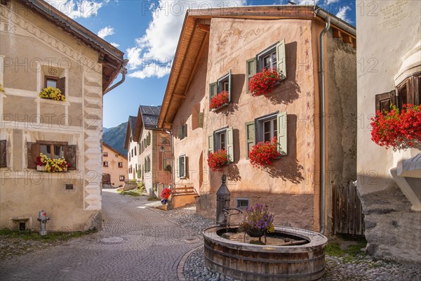 Village square with fountain and typical houses