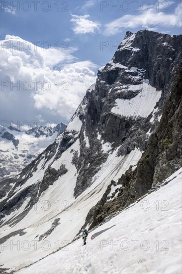 Hiker crosses snow field