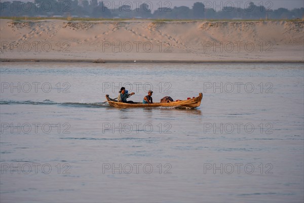 Boat with people goes on Irrawaddy River