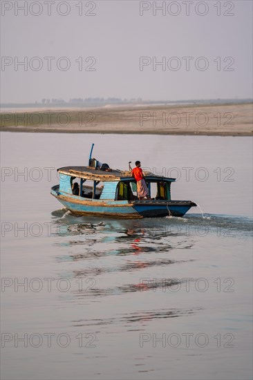 Boat with people goes on Irrawaddy River