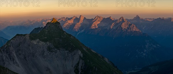 Summit of the Pfeilspitze in the foreground and Hornbachkette in the background at sunrise
