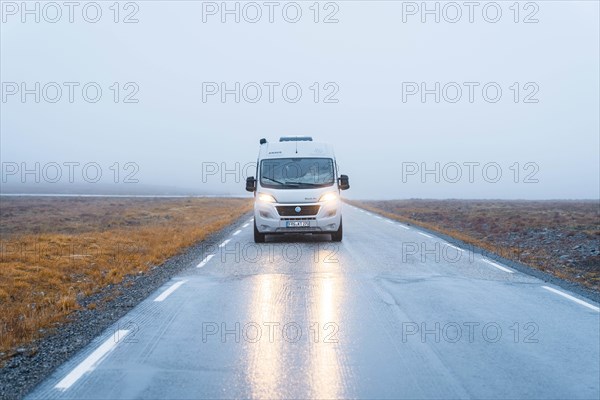 Campervan with bright lights on road near the North Cape