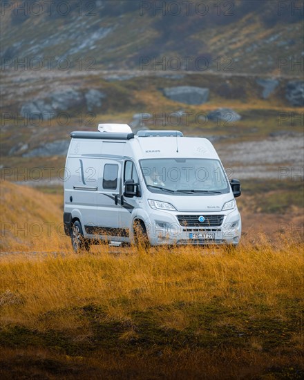 Campervan parked on grassed parking lot near Kafjord