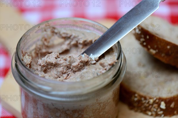 Liver sausage in glass with knife