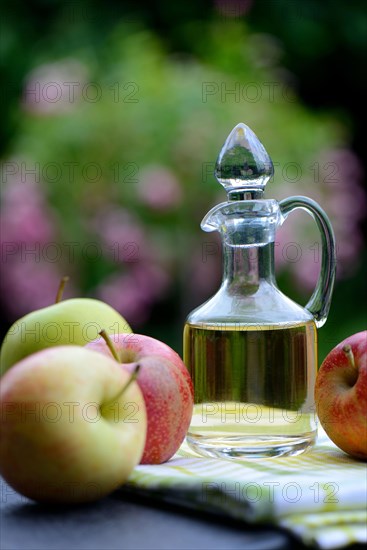 Carafe with apple vinegar and apples