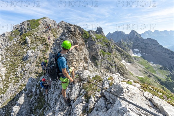 Mountaineer on a ridge on a secured fixed rope route