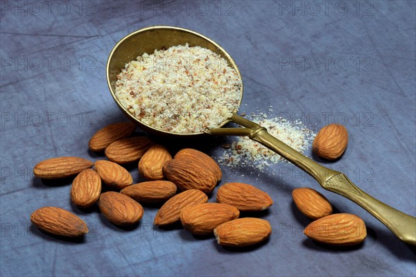 Ground almonds in brass ladle