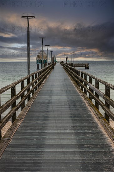 Diving gondola at the pier at sunrise on the beach of Zingst