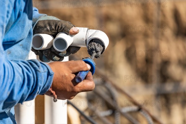 Plumber applying pipe cleaner