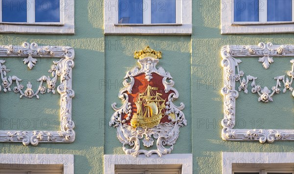 Stucco with sailing ship on a baroque facade of a residential house