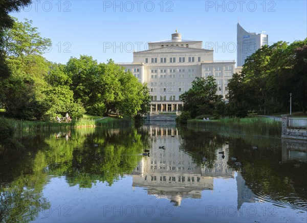 Swan pond with opera and city skyscraper