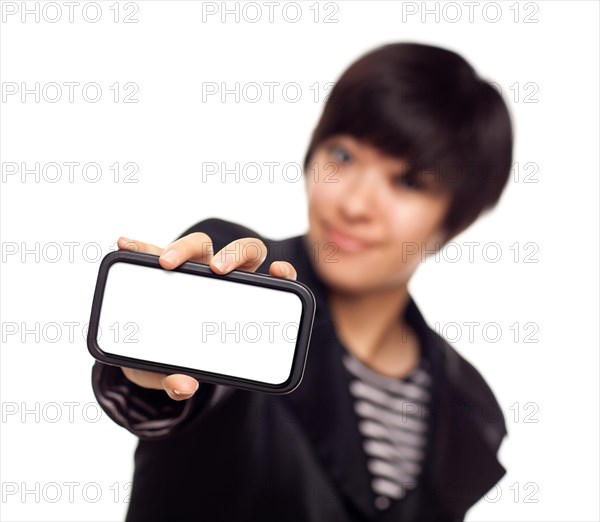 Smiling young mixed-race woman holding blank smart phone out