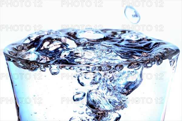 Glass filled with bubbling water