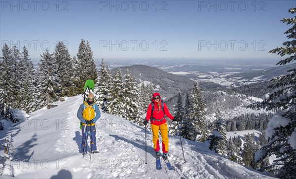 Young woman and man on ski tour