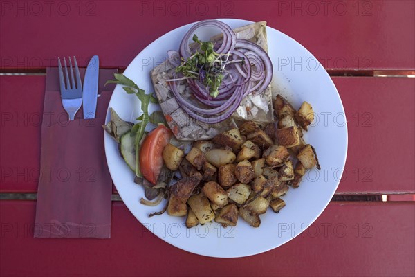 Brawn served with fried potatoes in a garden restaurant