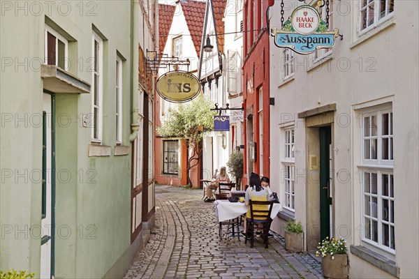 Outdoor restaurant in a small alley in the old town in the Schnoor or Schnoorviertel