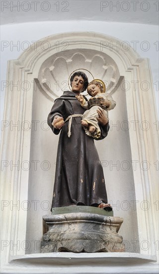 Saint figure with Jesus child and bread