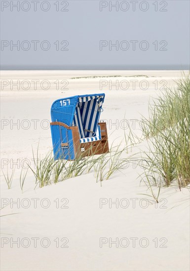 Beach chair with dunes at the beach