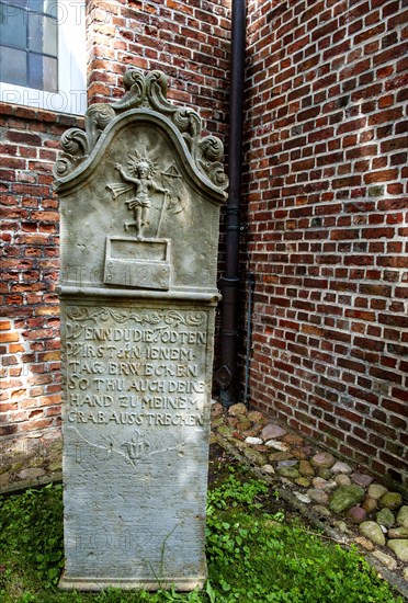 Historic sandstone gravestone from the 18th century in the churchyard of St. Nicholas Church