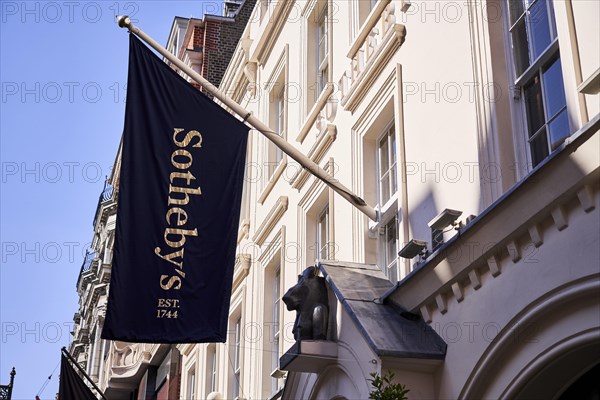 Sotheby's flag on old house wall