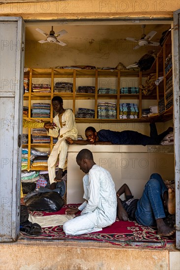 Boys hanging out in a shop in the bazaar