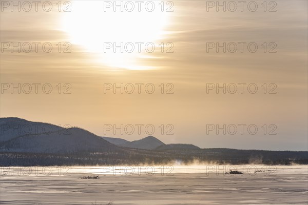 Sunset over a frozen river along the Road of Bones