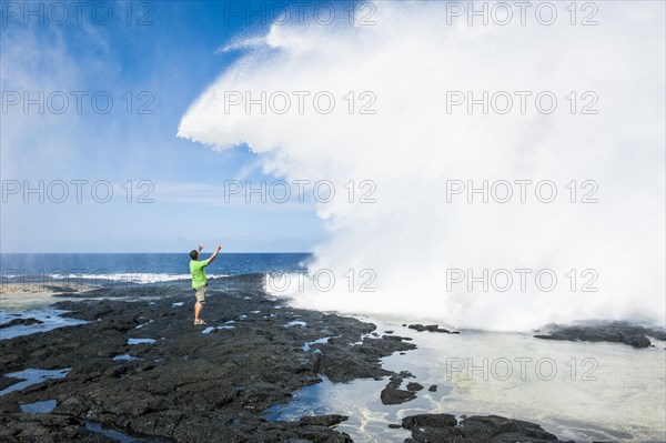 Tourist enjoying the huge waves in the Alofaaga blowholes on the south of SavaiÂ´i