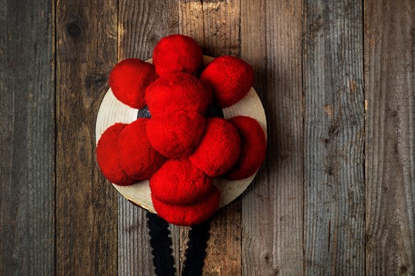 Original Black Forest Bollen hat in front of rustic wooden wall