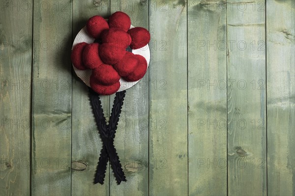 Original Black Forest Bollen hat in front of green wooden wall