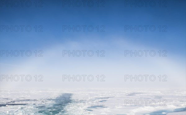 Fog bow or white rainbow in the ice around the North Pole