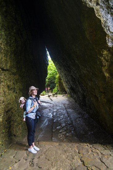 Womna hiking with her baby through the Unesco world heritage site