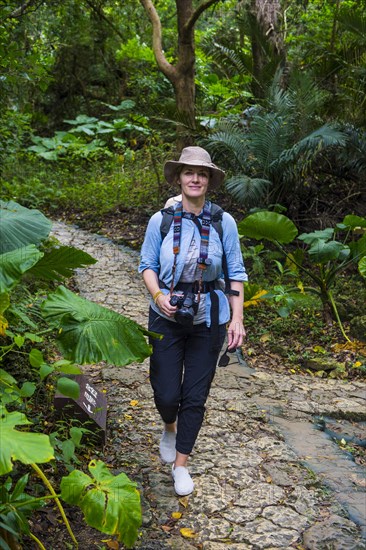 Womna hiking with her baby through the Unesco world heritage site