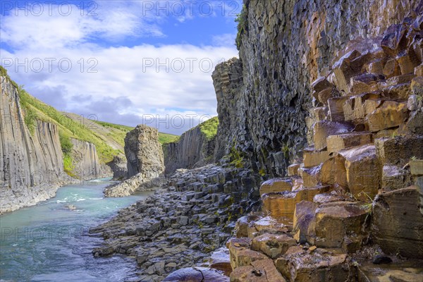 Basalt columns coloured orange by iron oxide