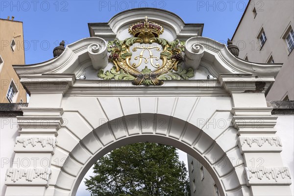 Royal coat of arms above a gateway