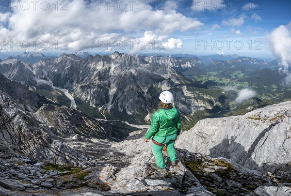 Hiker with helmet at the summit of the Watzmann