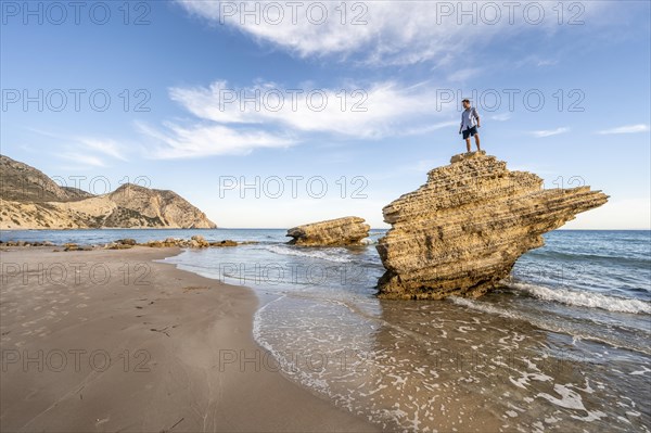 Young man standing on a rock