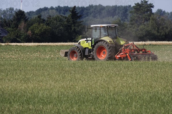 Farmer is cultivating field