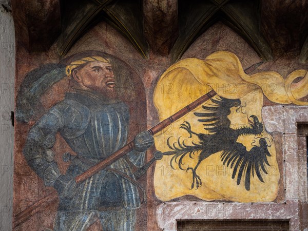 Banner bearer with armour carries yellow flag with black eagle