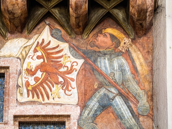 Banner bearer with armour carries white flag with red eagle